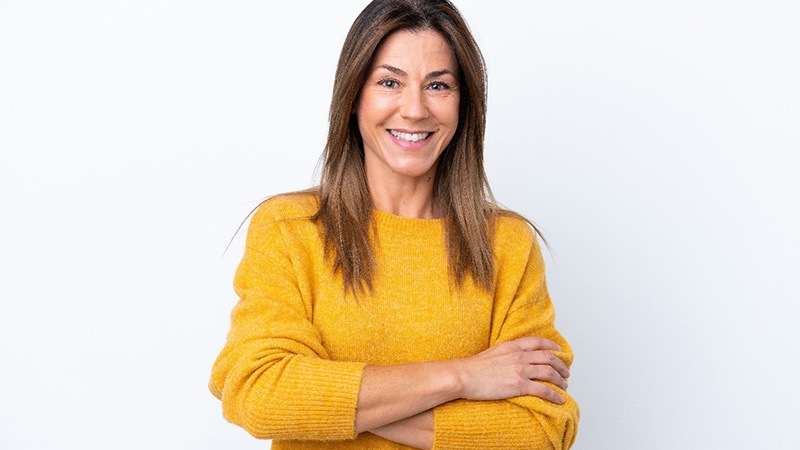 Smiling middle-aged woman in yellow sweater