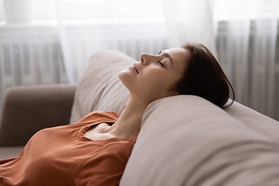 Woman relaxing on sofa at home