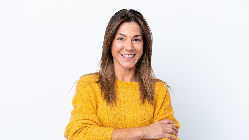 Smiling middle-aged woman in yellow sweater