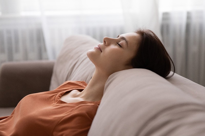 Woman relaxing on sofa at home