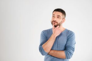 Man with thoughtful, contemplative expression on his face